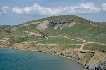 View of the hills by the sea from a height.Wild picturesque area. Beautiful summer background.