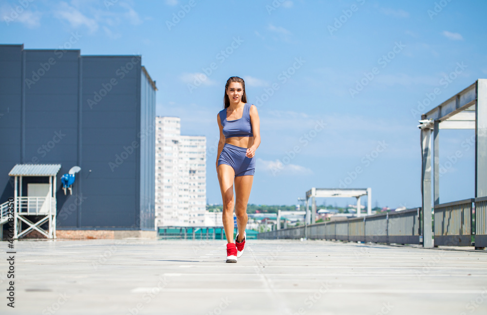 Wall mural portrait of a young beautiful woman in blue bikini