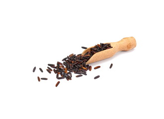 Pile of Brown Rice in a wooden spatula isolated. Organic black rice isolated on white background.
