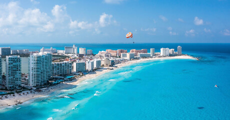 Aerial view of Punta Norte beach, Cancun, Mexico. Beautiful beach area and parachute flying over...