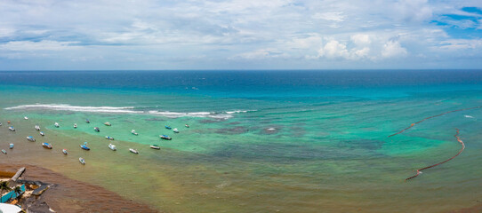 Aerial view of many sailing boats anchoring next to reef near the Playa Del Carmen town. Bird eye...