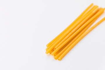 Top view of eco-friendly pasta straws on light background with copy space