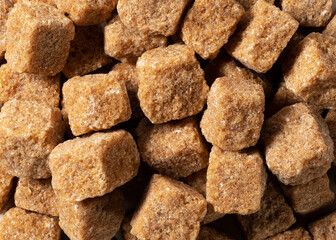 Brown cane sugar cubes all over the screen.