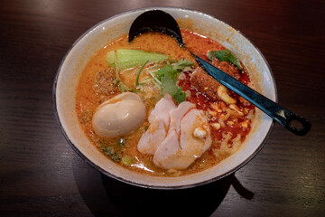 Spicy Miso Ramen, Japanese noodle soup, with chicken, boiled egg and green onion.