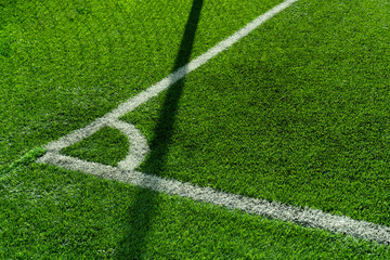 Fototapeta premium green artificial grass football or soccer field with corner white line background