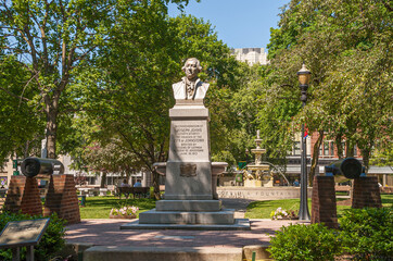 Johnstown, PA, USA - June 11, 2008: Closeup of Joseph Johns statue in Central park under green foliage and sun on face.