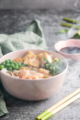 asian rice noodle soup with fried tofu and shrimps