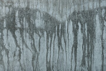 stone texture of white dirty concrete wall with gray wet water