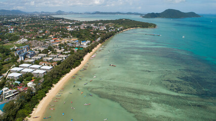 Aerial View of Thai traditional longtail fishing boats in the tropical sea beautiful beach in phuket thailand.