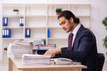 Young male employee unhappy with excessive work