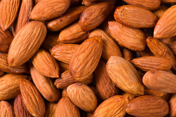 Delicious roasted sweet almonds nuts  background