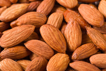 Delicious roasted sweet almonds nuts  background