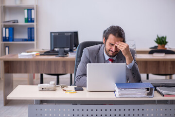 Young male employee working in the office