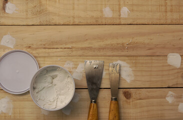 Putty knife and the wooden floor.