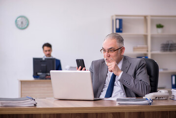 Two male employees working in the office