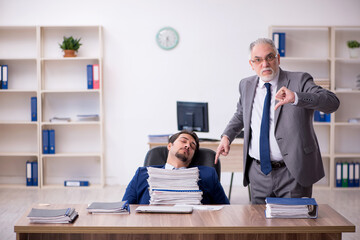 Two male employees and too much work in the office