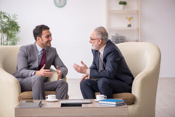 Two businessmen discussing project at workplace
