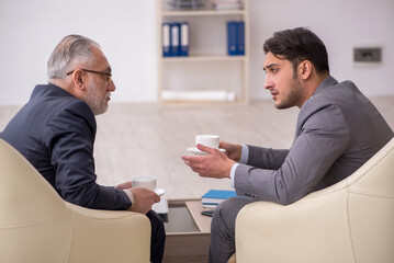 Two businessmen discussing project at workplace