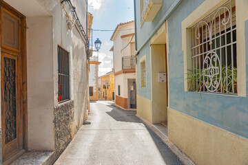 Fototapeta na wymiar Narrow picturesque typically European street with pastel color building