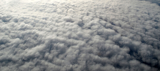 Obraz premium Aerial view of clouds and sky. Bird eye view from airplane window. Clouds panorama from airplane. Flight from Kiev to Sharm El Sheikh, Egypt.