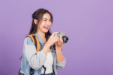 woman smiling excited wear denims and bag holding vintage photo camera