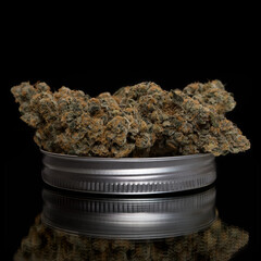 Close up of Cannabis on a wide mouth mason jar lid.