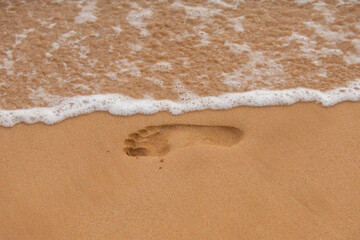 Texture background footprints of human feet on the sand on the sandy.