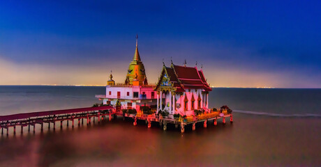 Beautiful scene of thai temple at Wat Hong Thong temple at Chachoengsao province Thailand. It's popular thai temple in Thailand. Buddhist church and gold pagoda in the sea.