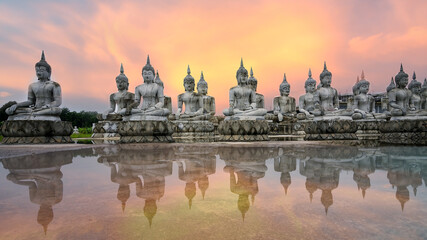 Face of Buddha statue,Many ancient Buddha images reflected by water,Ancient Thai Architecture.