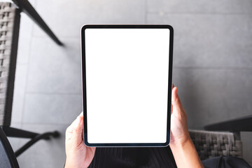 Top view mockup image of a woman holding digital tablet with blank white desktop screen