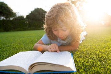 Cute childr boy with books outdoors. Summer camp. Kids learning and education concept.