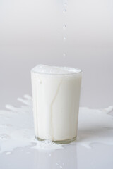 Fresh milk in a spilled glass for extraordinary