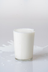 Fresh milk in a spilled glass for extraordinary