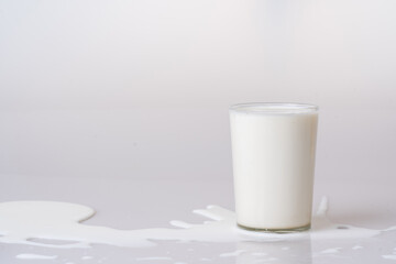 Fresh milk in a spilled glass for extraordinary