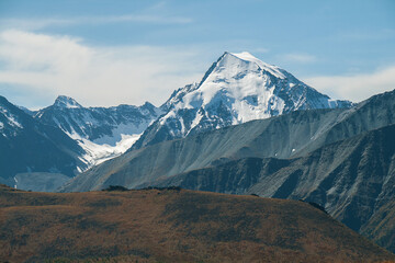 Mountain peak covered with snow. Mystical drawing of a face on the mountain.