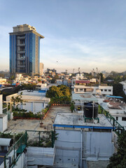 A sunlit view of rooftops and buildings in downtown Bangalore, India on a clear sunny day