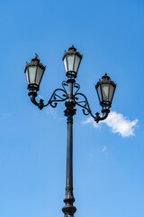 Fototapeta na wymiar City lantern on a background of blue sky