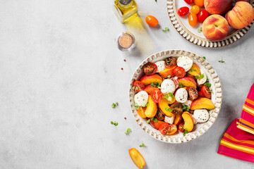 Summer peach Caprese salad with mozzarella and cherry tomatoes. Top view.
