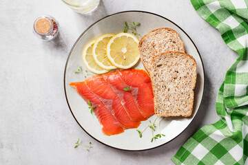 Salted salmon slices for healthy breakfast sandwiches. Organic fish. Light gray background. Top view.