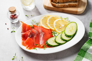 Salted salmon slices for healthy breakfast sandwiches. Organic fish. Light gray background.