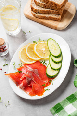 Salted salmon slices for healthy breakfast sandwiches. Organic fish. Light gray background.