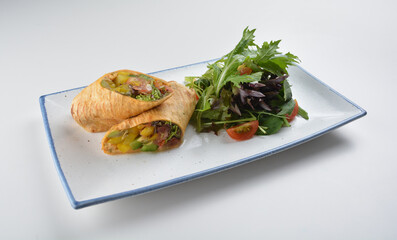 vegetarian pan tortilla wrapped with salad and dressing on white background vegan halal menu