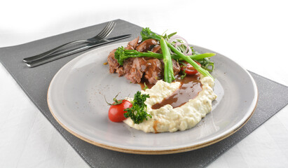 grilled juicy wagyu beef tenderloin or sirloin steak in brown sauce with egg mayo potato and asparagus vegetables western halal menu