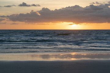 Fototapeta na wymiar Sunrise over the ocean with beautiful orange and blue tones