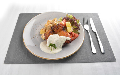 grilled bbq chicken breast meat with potato salad and lemon creamy tartar sauce on white background western halal menu