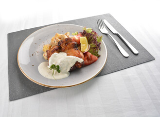 grilled bbq chicken breast meat with potato salad and lemon creamy tartar sauce on white background western halal menu