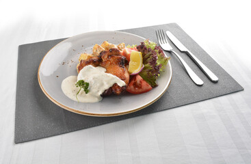 grilled bbq chicken breast meat with potato salad and lemon creamy tartar sauce on white background western halal menu