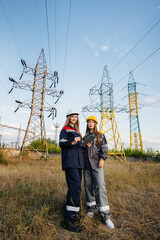 Women's collective of energy workers conducts an inspection of equipment and power lines. Energy