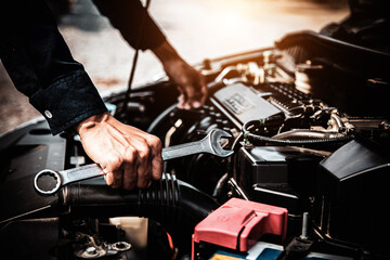 Car care maintenance and servicing, Close-up hand technician auto mechanic using the wrench to repairing change spare part car engine problem. Concepts of check and during periodic inspection service.