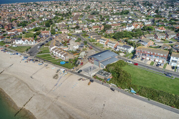 East Beach in Selsey West Sussex with small boats lined up on the wide shingle beach at this popular tourist destination. Aerial photo.